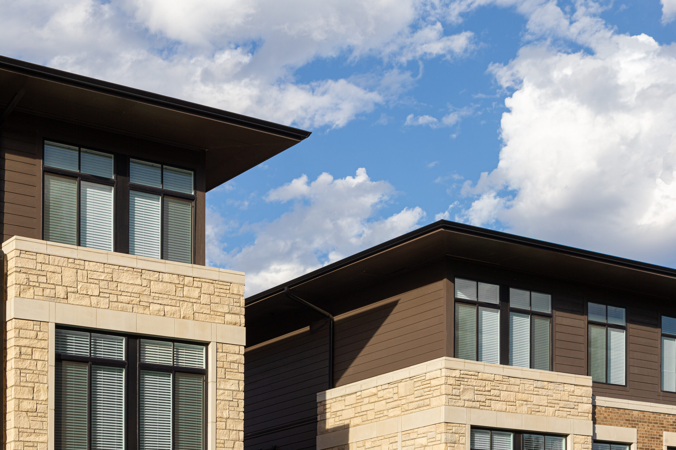 Parallel flat roofs of the two apartment buildings.