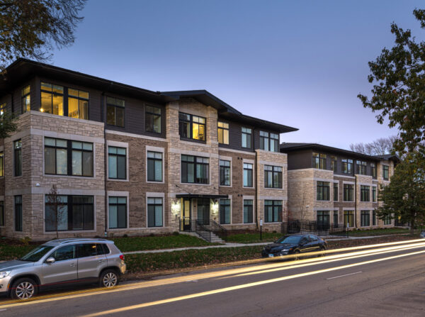 Street view of Church and Prairie apartment building at dusk.