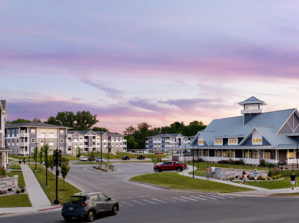 Panoramic view of the Solace at Mahomet multifamily development from the entrance at twilight.