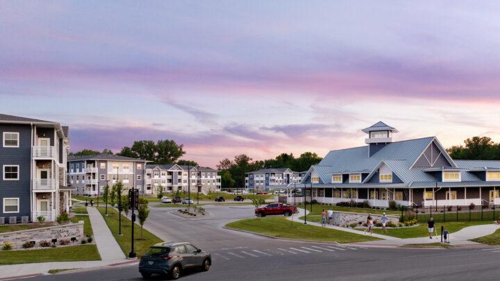 Panoramic view of the Solace at Mahomet multifamily development from the entrance at twilight.