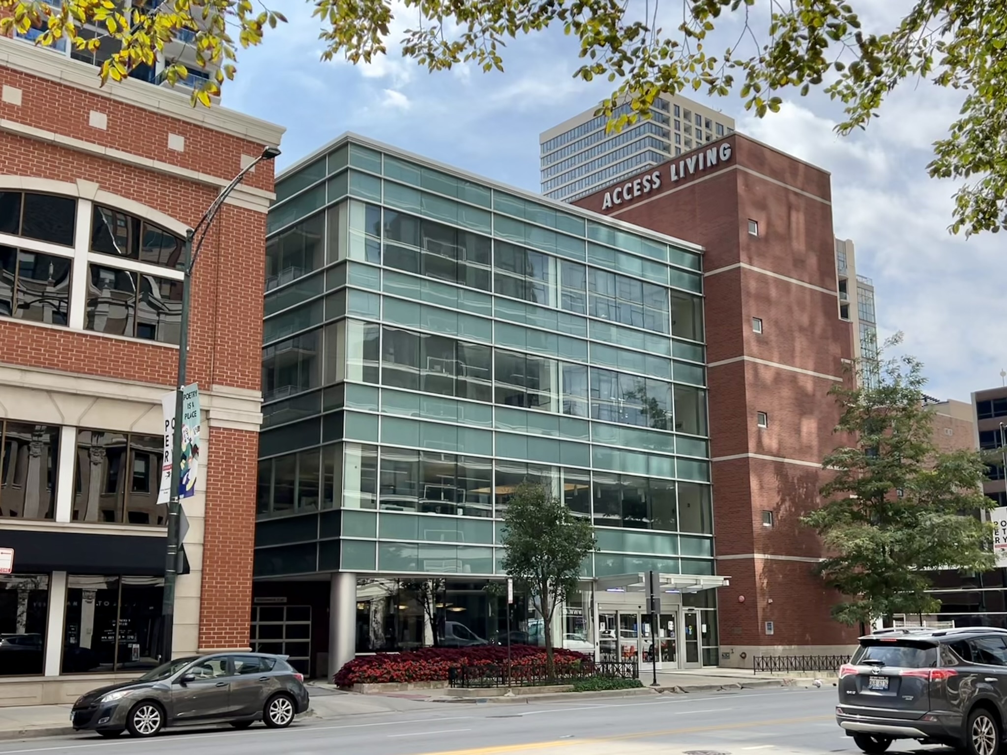 Exterior street view of Access Living headquarters building with cars passing by.