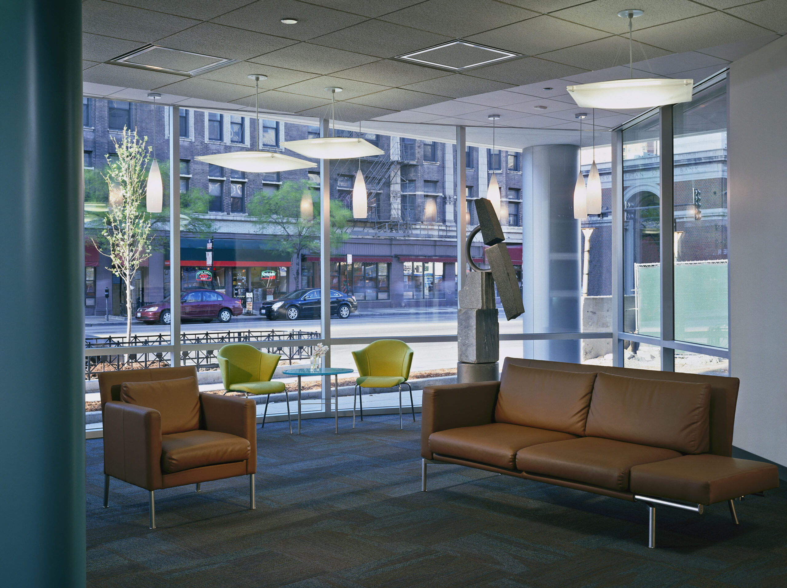 Lounge with two seating arrangements in the reception area of Access Living headquarters building.