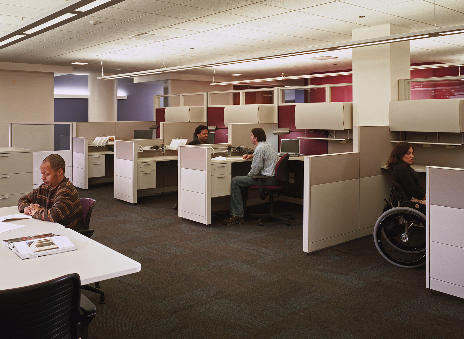 People at accessible working stations at Access Living headquarters building.