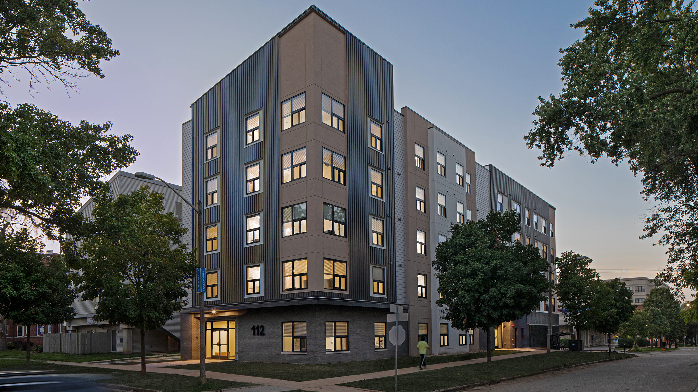 112 E John Street apartments perspective view from south-east side at twilight.