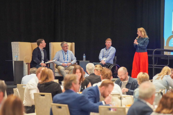 Dan Ryan, Doug Anderson, Luke Spink and Mary Malloy on stage during a panel discussion.