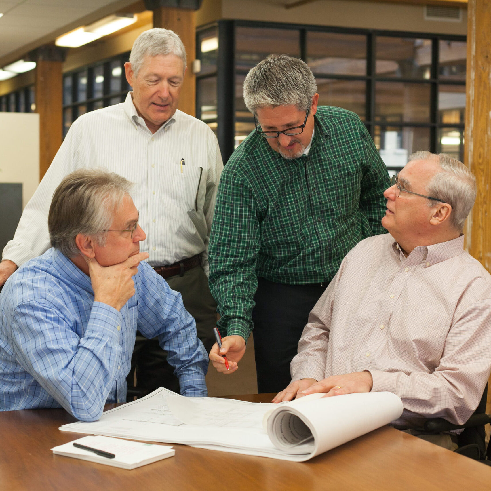 Partners Doug Mohnke, Richard Lehner, Doug Anderson, and Jack Catlin gathered around a table.