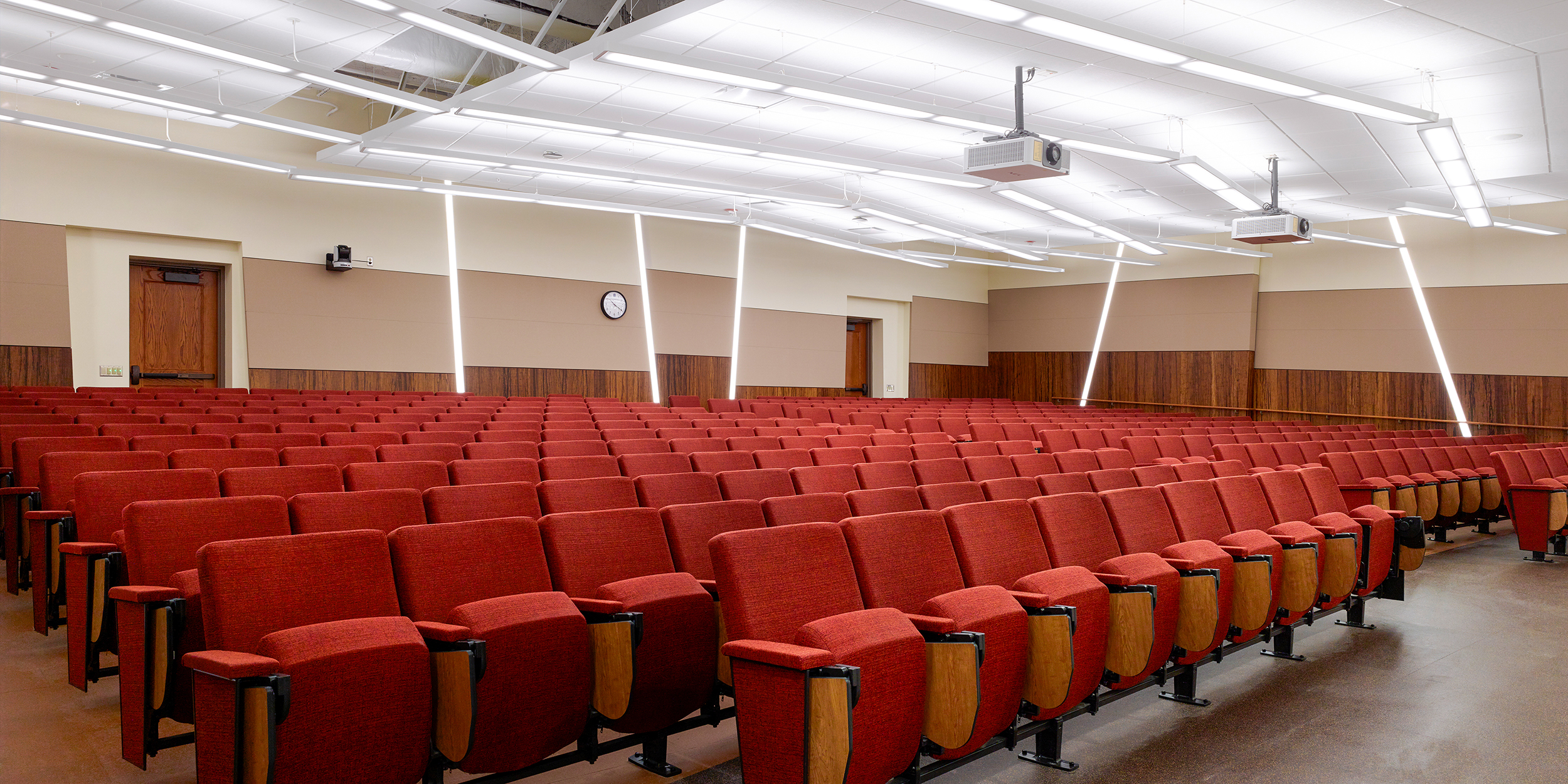 Natural History Building Lecture Hall with red upholstered fixed seating.