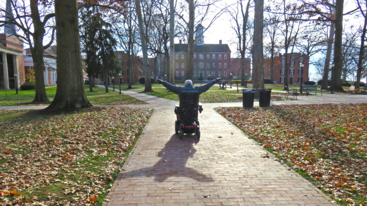 Jack Catlin in a wheelchair on a college campus.