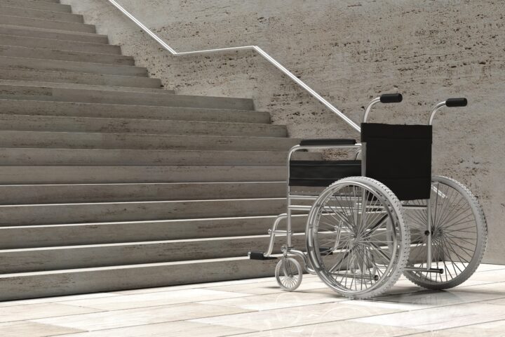 A wheelchair in front of a staircase.