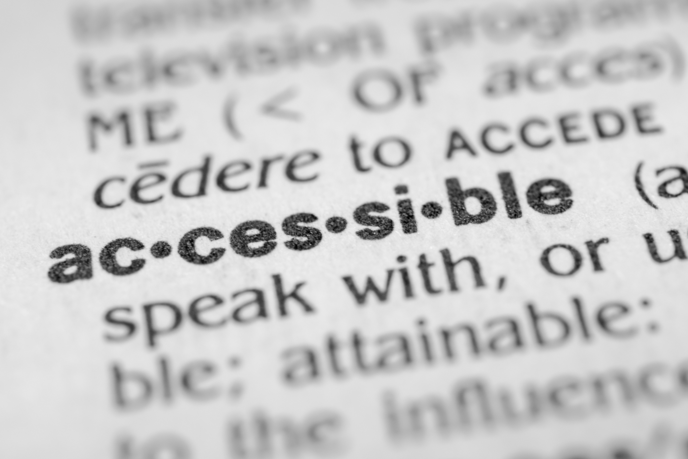 A close up of a dictionary with the word accessible in focus.