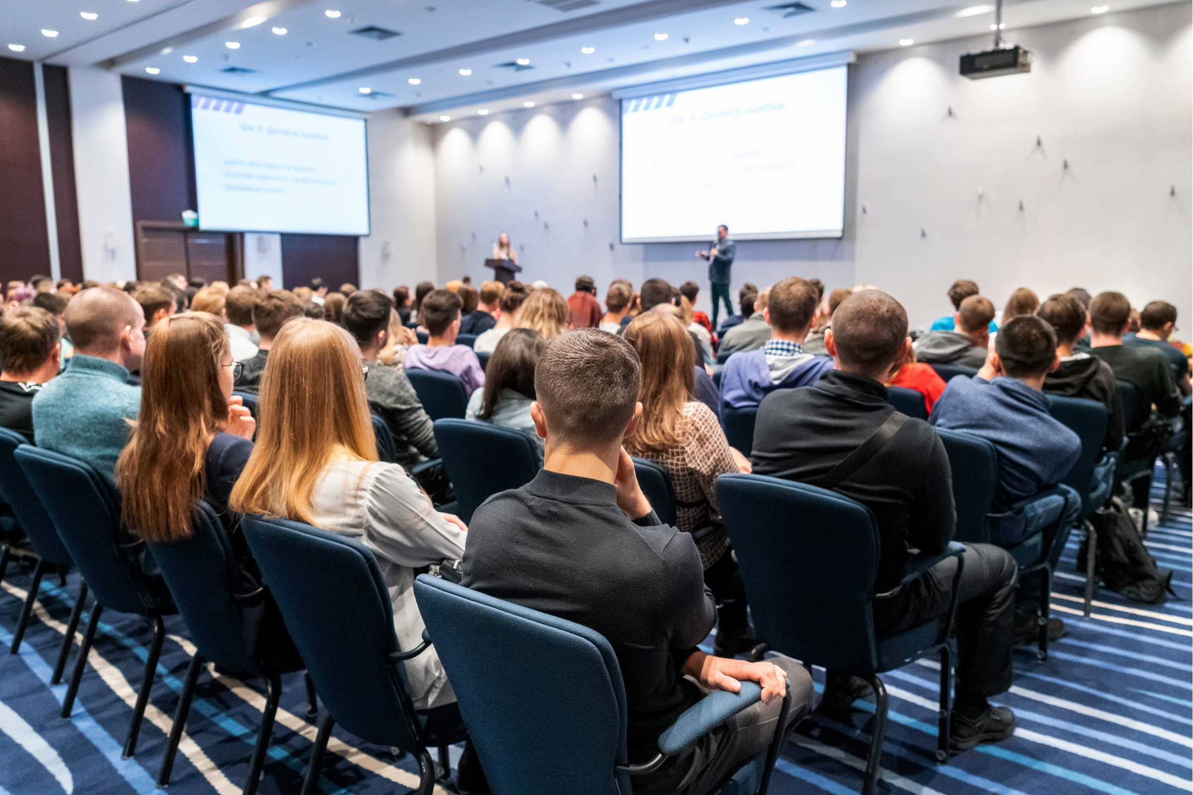 A room full of people listening to a presenter.