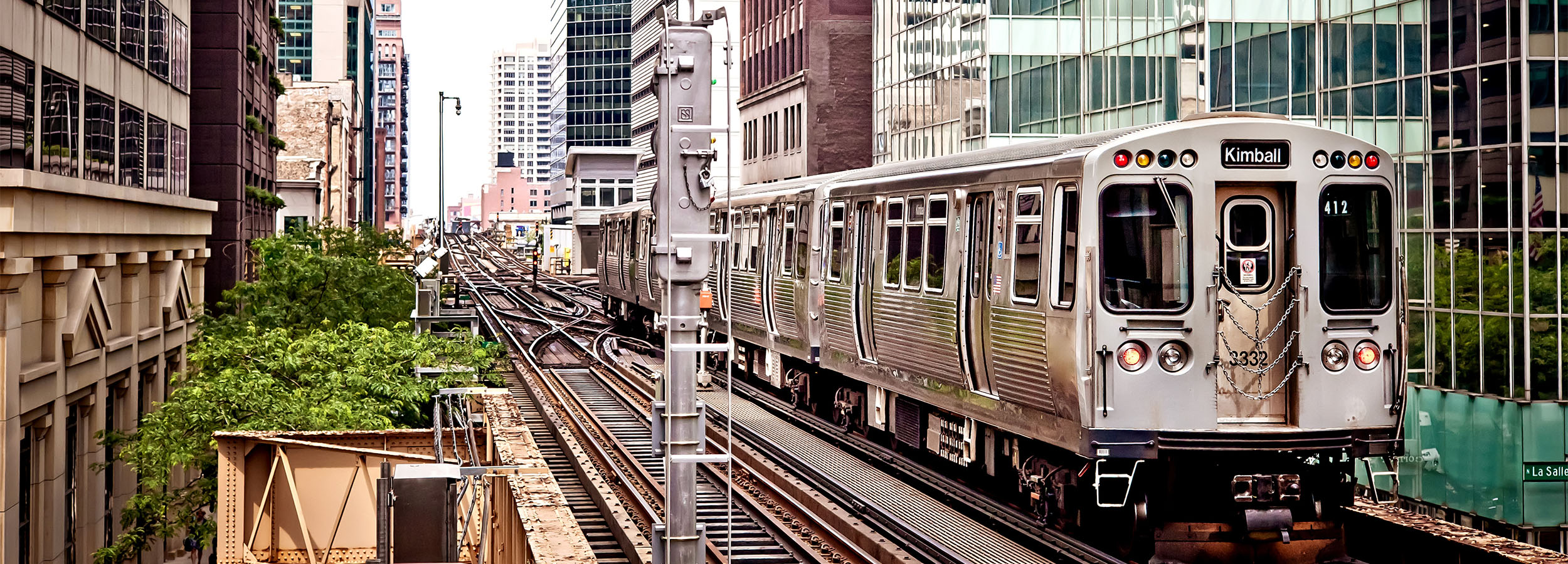 Train on an elevated railway in the middle of the city.